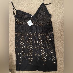 Free people xs black sequin tank top NWT. Adjustable spaghetti straps.